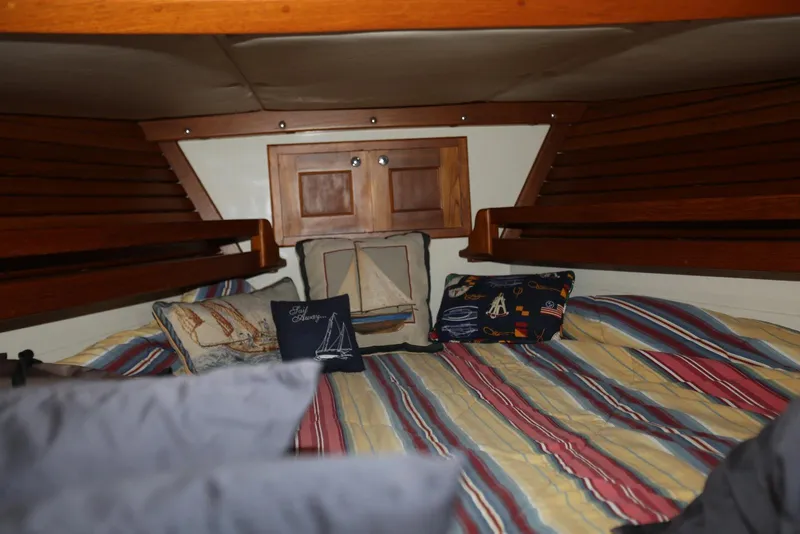 Slide: The Image of Cozy cabin interior of 2004 Pacific Seacraft Crealock 40 sailboat with nautical-themed pillows. - 35