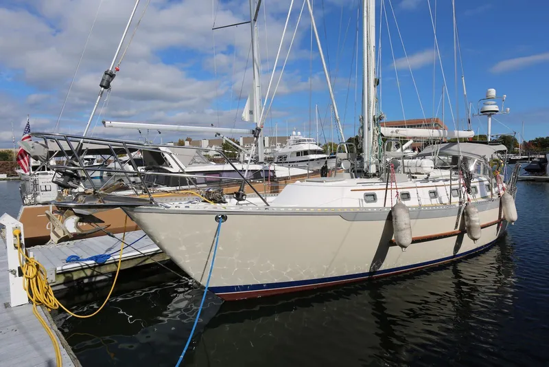 Slide: The Image of 2004 Pacific Seacraft Crealock 40 sailboat docked at marina under blue sky. - 4