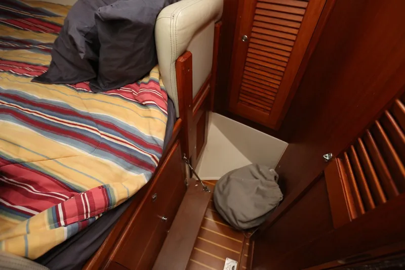 Slide: The Image of Cozy cabin interior of 2004 Pacific Seacraft Crealock 40 sailboat with striped bedding. - 40