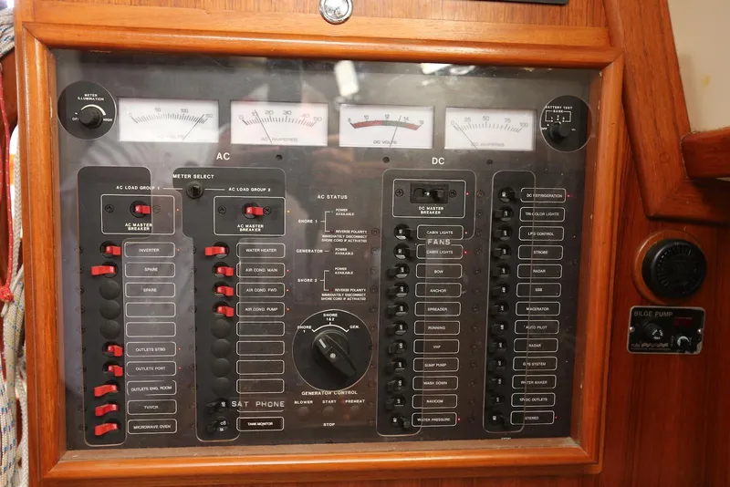 Slide: The Image of Electrical control panel on a 2004 Pacific Seacraft Crealock 40 sailboat, featuring AC and DC switches. - 43