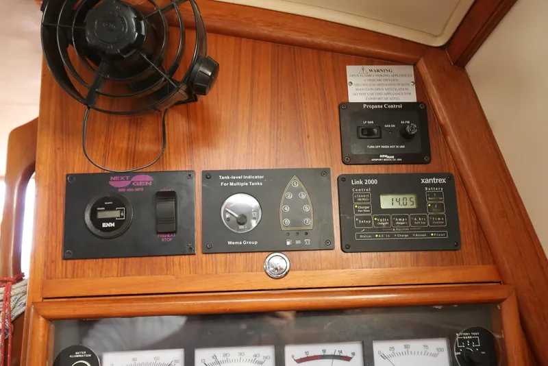 Slide: The Image of Control panel of a 2004 Pacific Seacraft Crealock 40 sailboat with fan and gauges. - 44