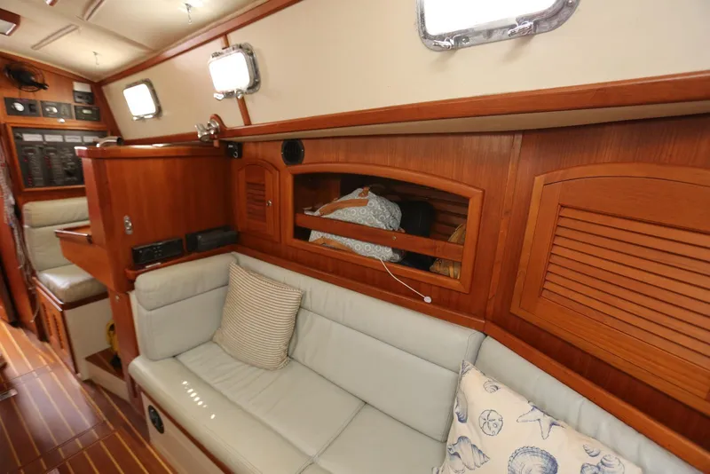 Slide: The Image of Interior of 2004 Pacific Seacraft Crealock 40 sailboat with wooden cabinetry and cushioned seating. - 49