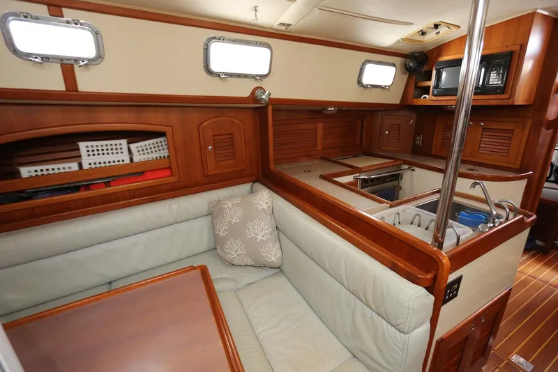 Slide: The Image of Interior of 2004 Pacific Seacraft Crealock 40 sailboat with cozy seating and kitchen area. - 50