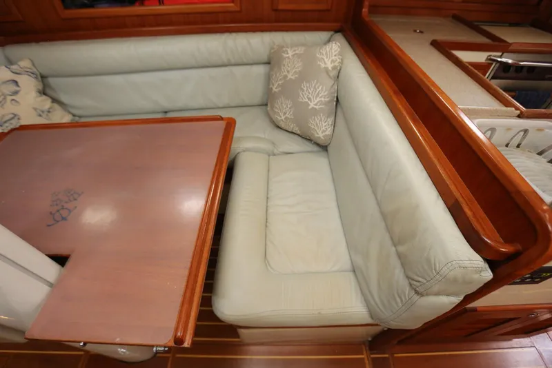 Slide: The Image of Interior of 2004 Pacific Seacraft Crealock 40 with cushioned seating and wooden table. - 51