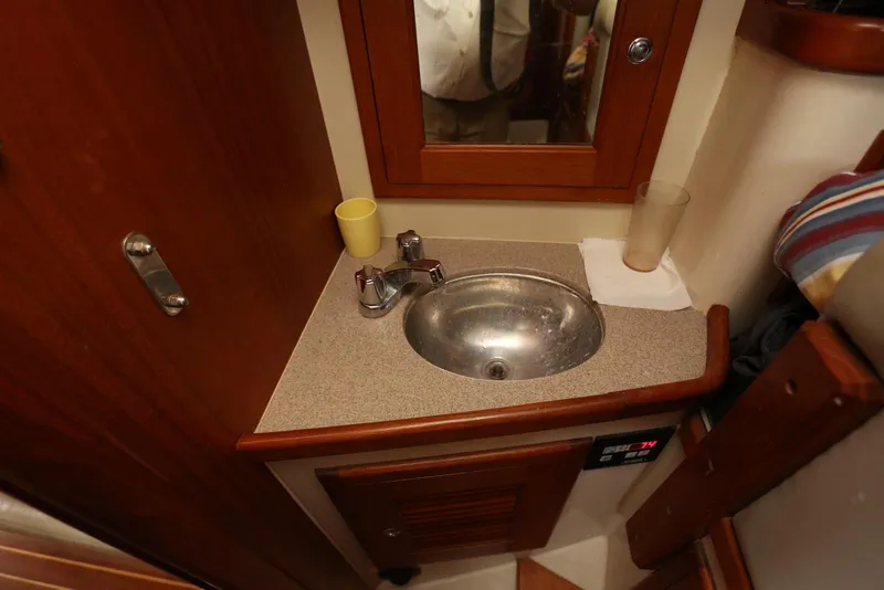 Slide: The Image of Compact bathroom sink area in 2004 Pacific Seacraft Crealock 40 sailboat. - 53