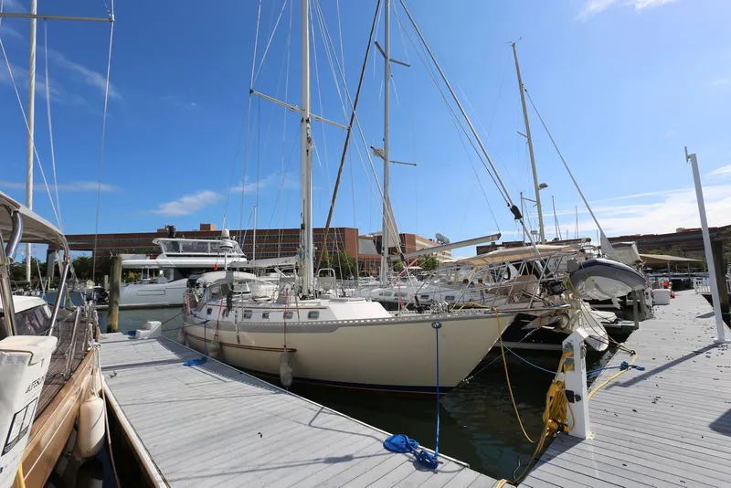 Slide: The Image of 2004 Pacific Seacraft Crealock 40 sailboat docked at marina under clear blue sky. - 6