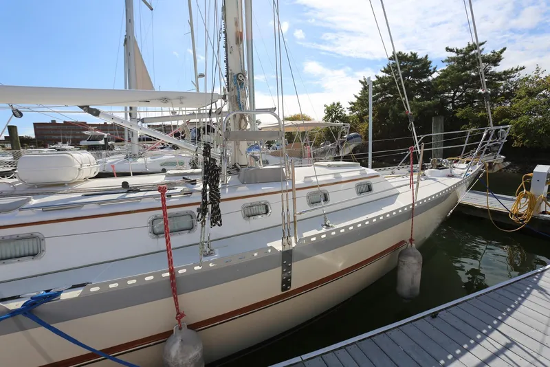 Slide: The Image of 2004 Pacific Seacraft Crealock 40 sailboat docked at marina under clear sky. - 7