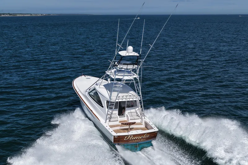 Slide: The Image of 2024 Viking 48 Sport Tower yacht cruising on open sea. - 10