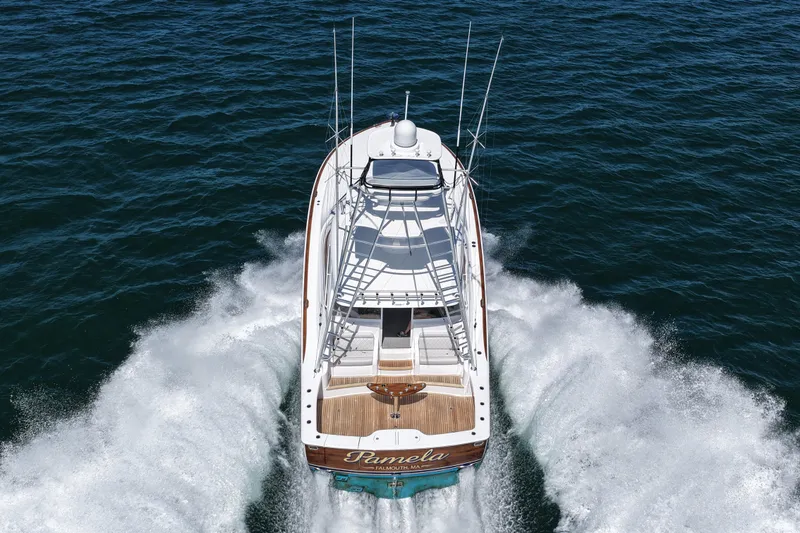 Slide: The Image of 2024 Viking 48 Sport Tower yacht cruising on open water, aerial view. - 11