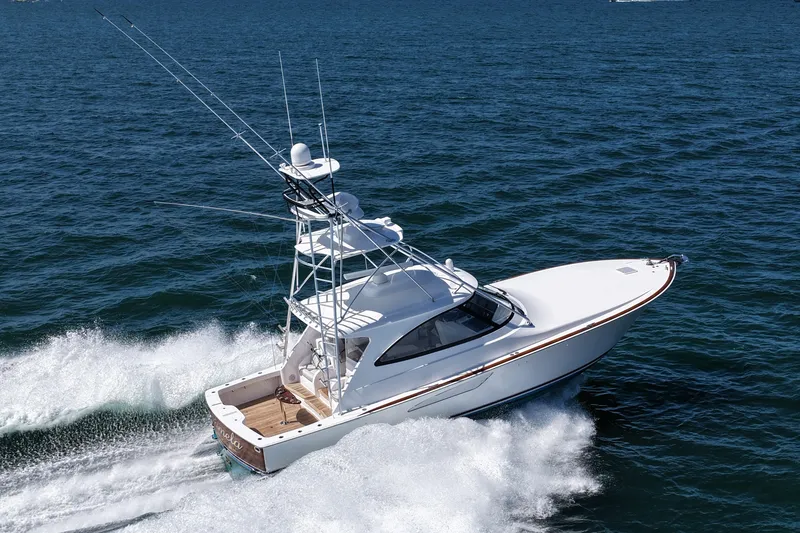 Slide: The Image of 2024 Viking 48 Sport Tower yacht cruising on open water. - 0