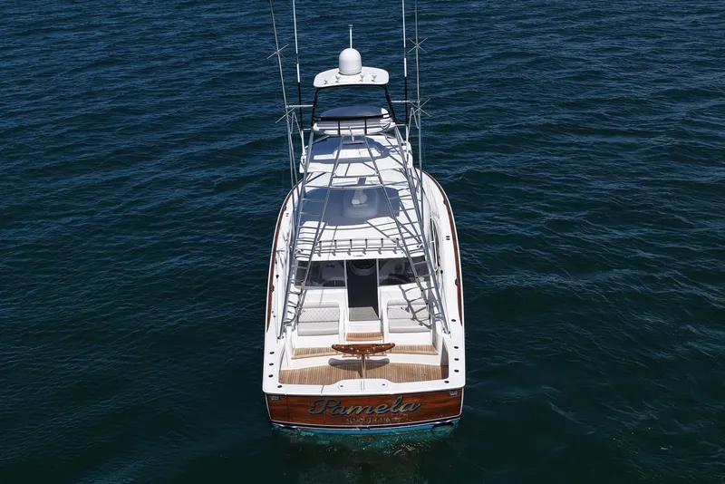 Slide: The Image of 2024 Viking 48 Sport Tower yacht on open water, rear view. - 25