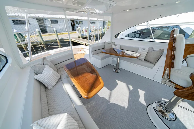 Slide: The Image of Luxurious interior of 2024 Viking 48 Sport Tower yacht with elegant seating and wooden table. - 33