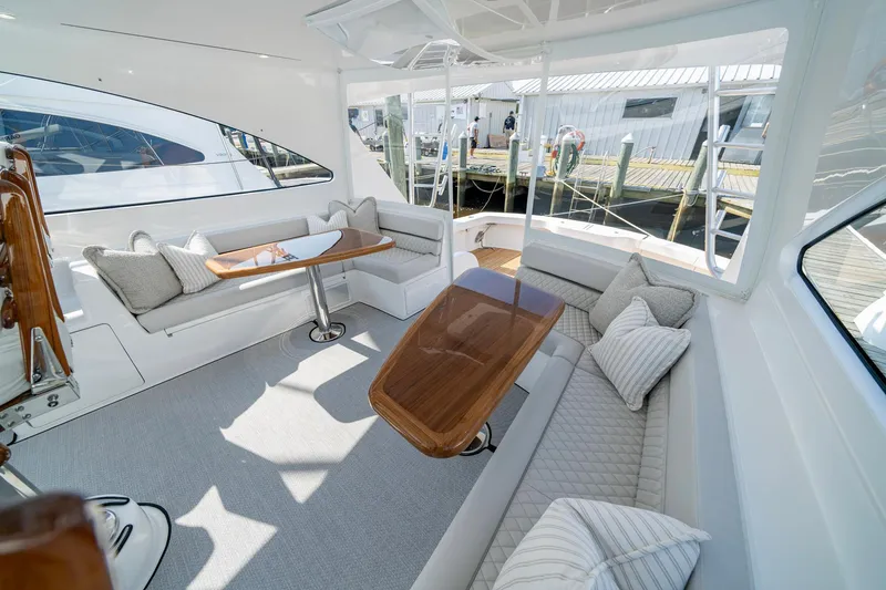 Slide: The Image of Luxurious interior of 2024 Viking 48 Sport Tower yacht with elegant seating and wooden tables. - 34
