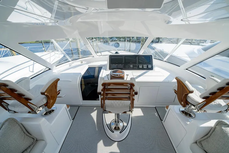 Slide: The Image of 2024 Viking 48 Sport Tower yacht interior with modern helm and luxurious seating. - 37