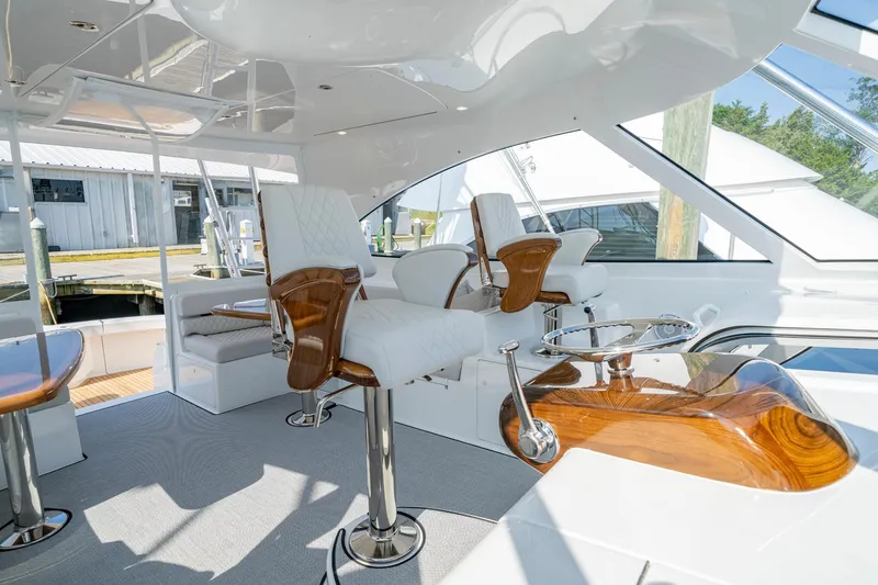 Slide: The Image of Luxurious interior of 2024 Viking 48 Sport Tower yacht with elegant seating and polished wood accents. - 38