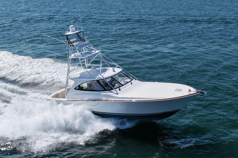 Slide: The Image of 2024 Viking 48 Sport Tower cruising on open water, showcasing sleek design and performance. - 4