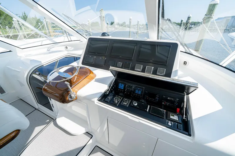 Slide: The Image of 2024 Viking 48 Sport Tower helm with advanced navigation controls and sleek design. - 41