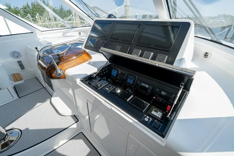 Slide: The Image of 2024 Viking 48 Sport Tower helm with advanced navigation controls and sleek design. - 43