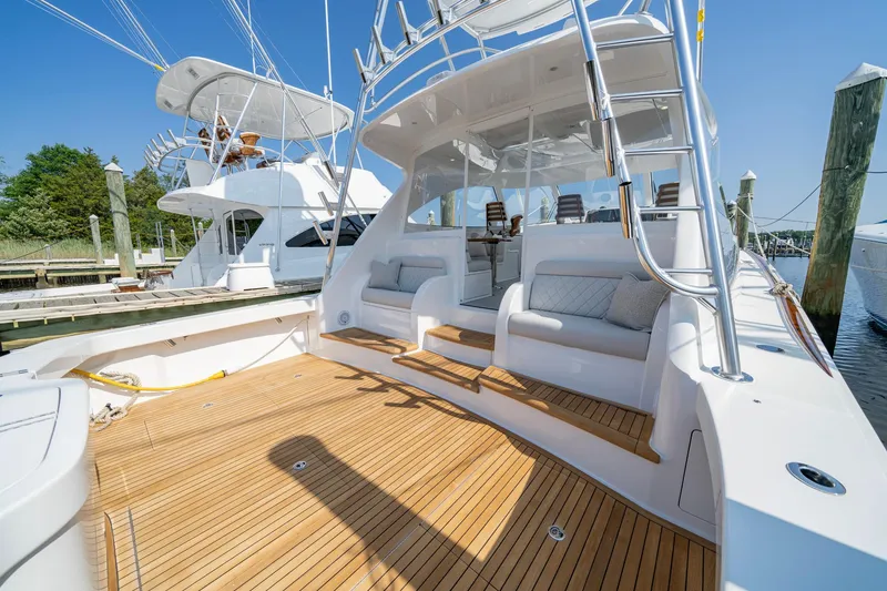 Slide: The Image of 2024 Viking 48 Sport Tower yacht with spacious deck and seating area. - 48