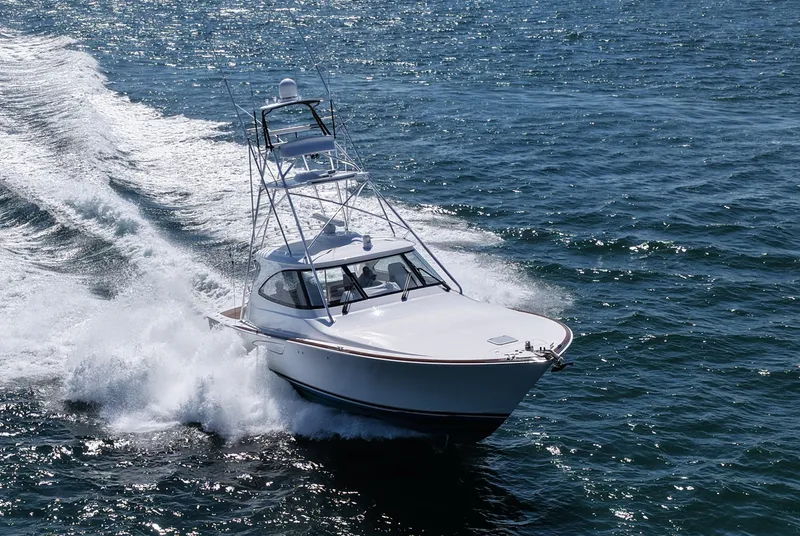 Slide: The Image of 2024 Viking 48 Sport Tower yacht cruising on open water. - 5