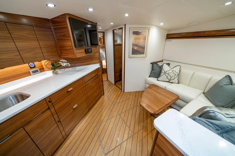 Slide: The Image of Luxurious interior of 2024 Viking 48 Sport Tower yacht with wood finish and modern amenities. - 52