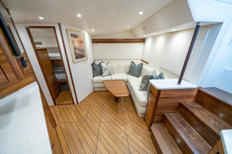Slide: The Image of Luxurious interior of 2024 Viking 48 Sport Tower yacht with elegant seating and wooden flooring. - 53