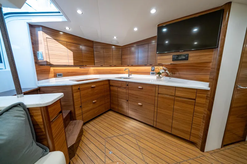 Slide: The Image of Luxurious interior of 2024 Viking 48 Sport Tower yacht with modern wood cabinetry and sleek design. - 54