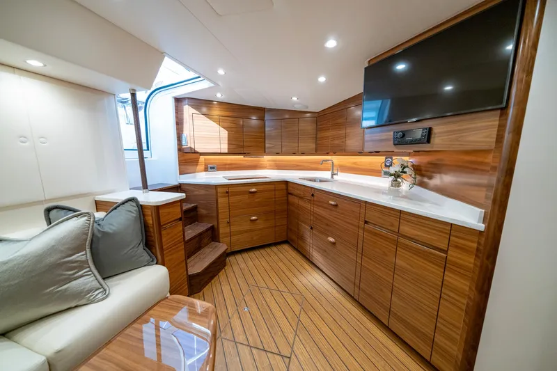 Slide: The Image of Luxurious interior of 2024 Viking 48 Sport Tower yacht with modern kitchen and seating area. - 55