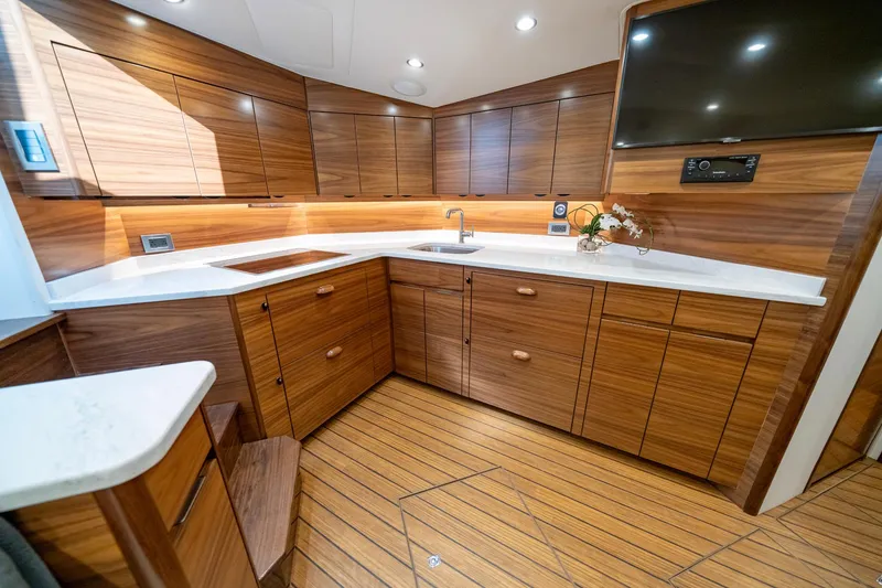 Slide: The Image of 2024 Viking 48 Sport Tower interior with wood finish and cozy bedroom. - 62