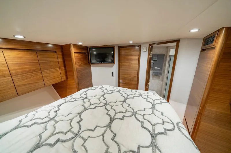 Slide: The Image of Luxurious cabin interior of 2024 Viking 48 Sport Tower with wood paneling and modern amenities. - 66