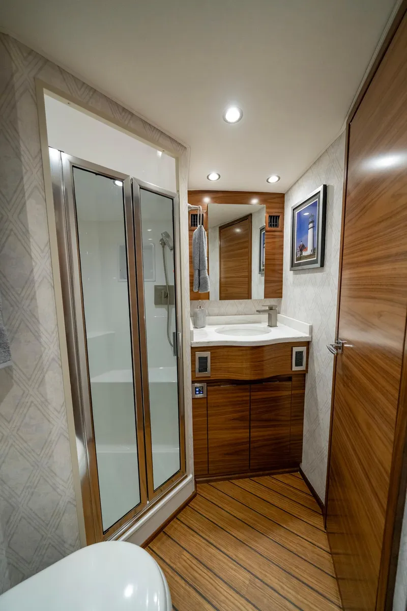 Slide: The Image of Luxurious bathroom interior of 2024 Viking 48 Sport Tower yacht with modern fixtures and wood accents. - 69