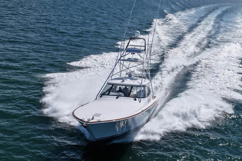 Slide: The Image of 2024 Viking 48 Sport Tower yacht cruising on open water. - 7