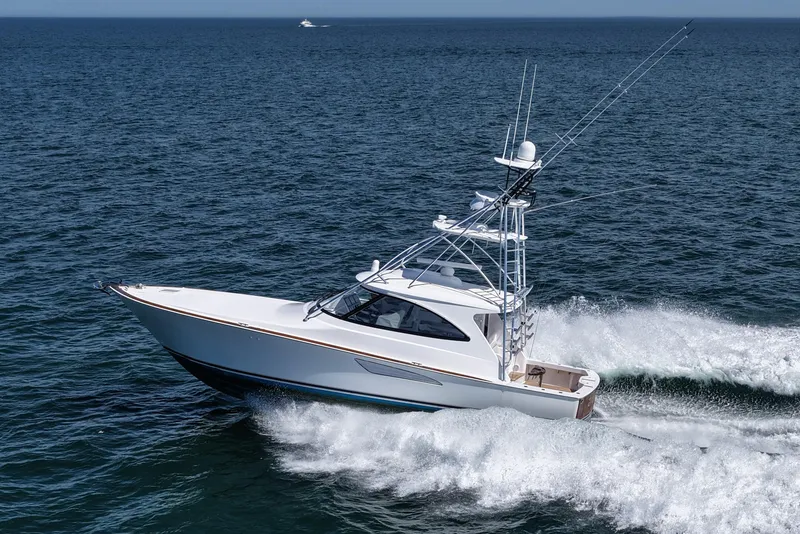 Slide: The Image of 2024 Viking 48 Sport Tower yacht cruising on open sea. - 9