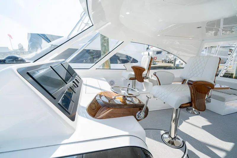 Slide: The Image of Luxurious interior of 2024 Viking 48 Sport Tower yacht with modern seating and controls. - 40