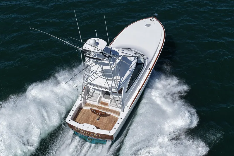 Slide: The Image of 2024 Viking 48 Sport Tower cruising on open water, aerial view. - 12