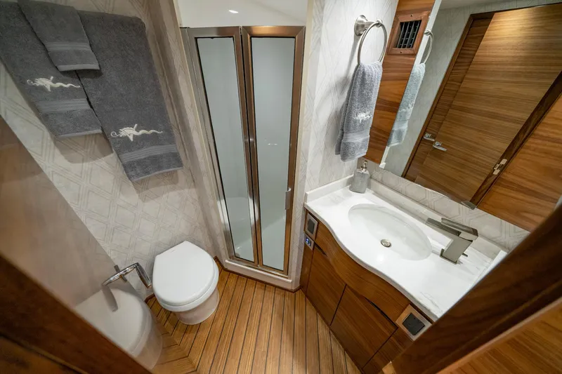 Slide: The Image of Luxurious bathroom in 2024 Viking 48 Sport Tower yacht with modern fixtures and wood accents. - 67