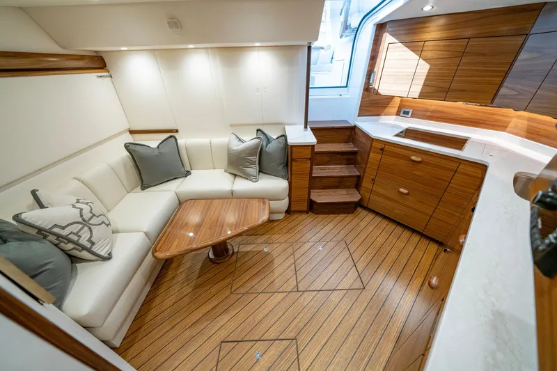 Slide: The Image of Luxurious interior of 2024 Viking 48 Sport Tower yacht with elegant wood finish and cozy seating. - 57