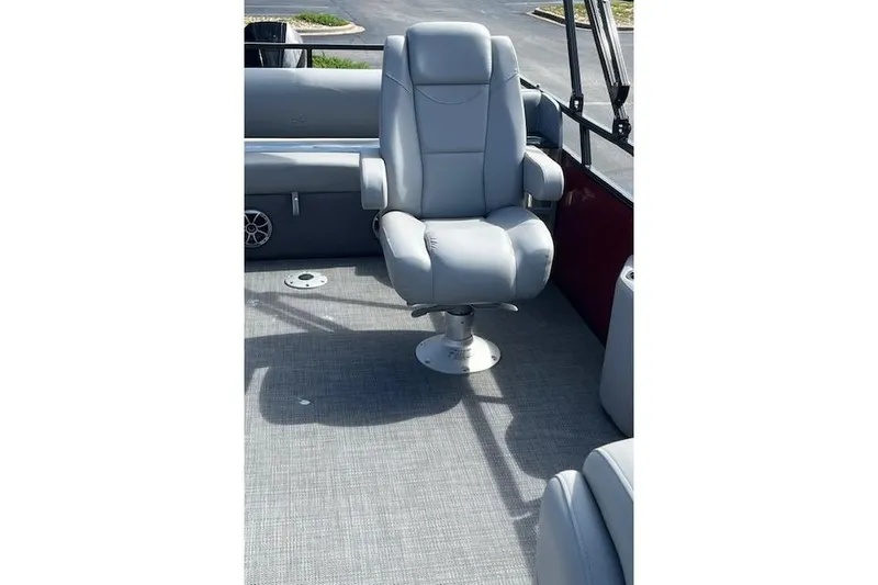Slide: The Image of 2024 Regency 250 DL3 boat with a luxurious gray captain's chair on deck. - 17