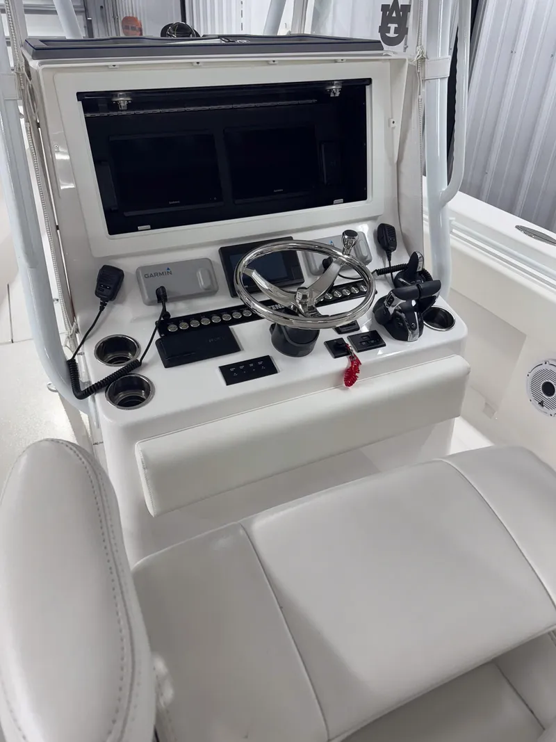 Slide: The Image of 2022 Contender 32 ST boat console with steering wheel and navigation controls. - 10