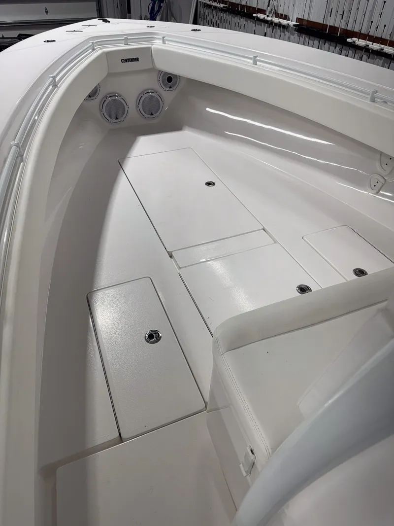 Slide: The Image of 2022 Contender 32 ST boat interior with white deck and storage compartments. - 12