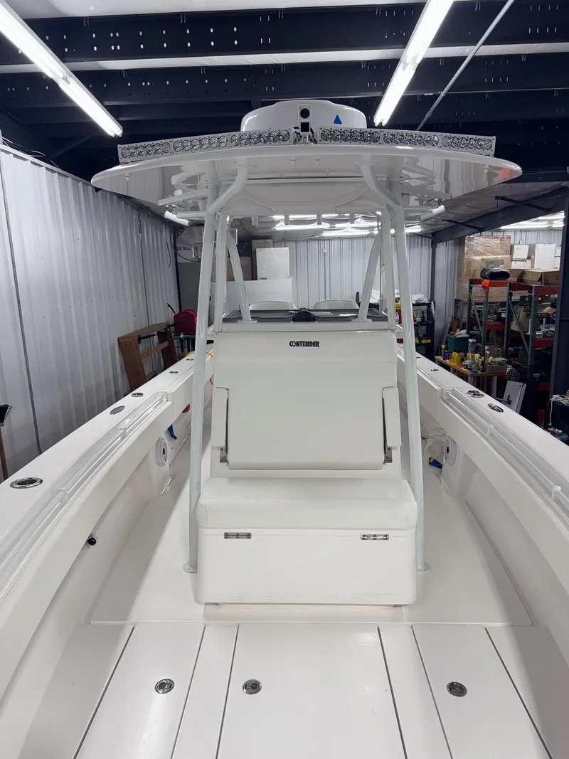 Slide: The Image of 2022 Contender 32 ST boat in a storage facility, showcasing sleek design and spacious deck. - 13