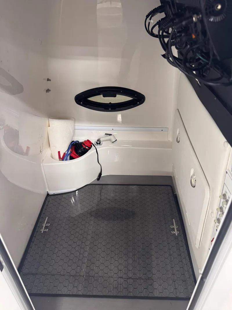 Slide: The Image of Interior of a 2022 Contender 32 ST boat, featuring storage and equipment space. - 16