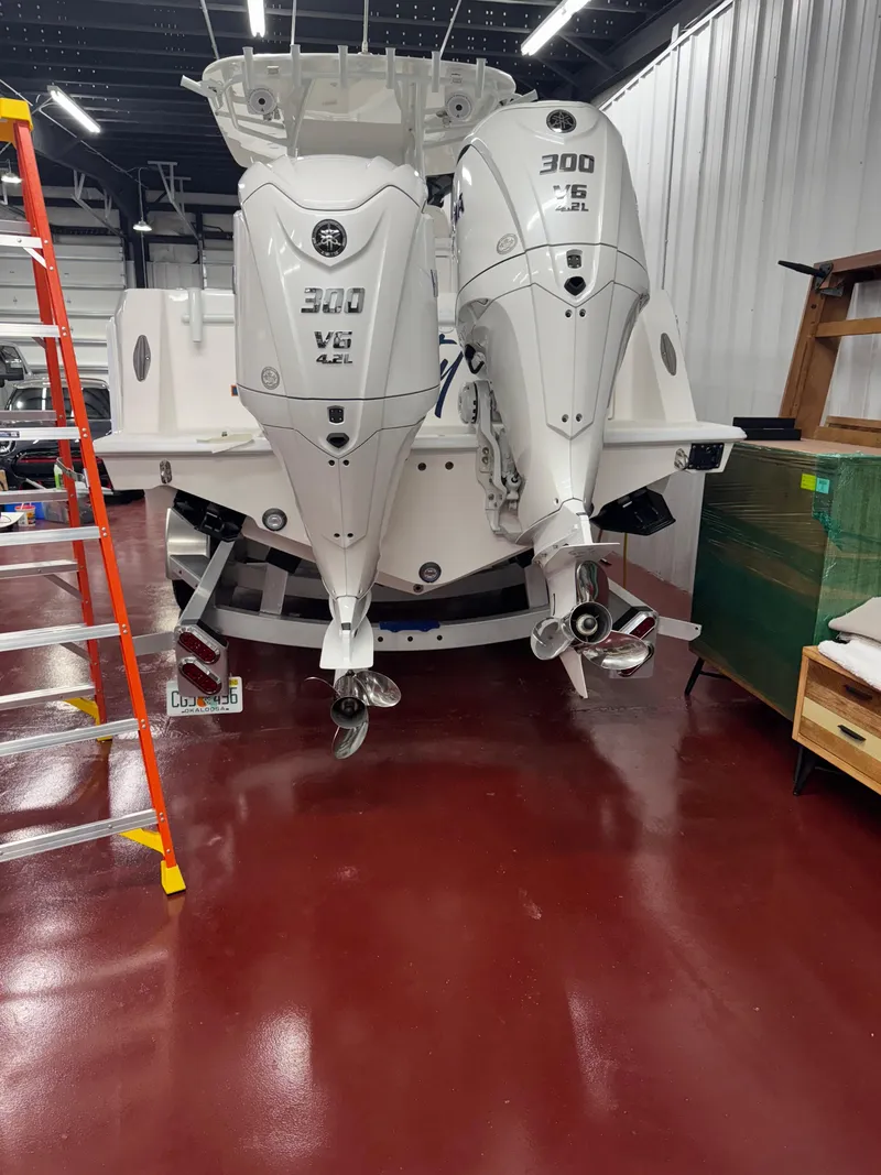 Slide: The Image of 2022 Contender 32 ST boat with twin 300 V6 engines in a garage. - 4