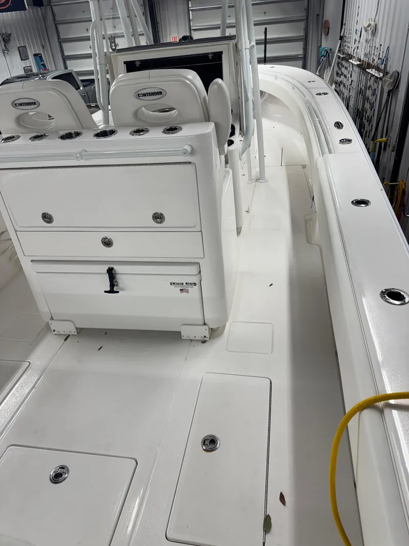 Slide: The Image of 2022 Contender 32 ST boat interior with seating and storage compartments. - 6