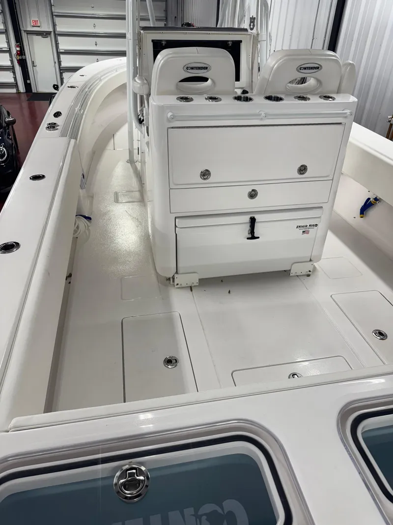 Slide: The Image of 2022 Contender 32 ST boat interior with seating and storage compartments. - 9