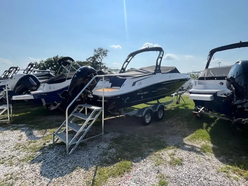 Slide: The Image of 2025 Bayliner VR6 Bowrider OB on trailer, displayed outdoors under clear sky. - 1