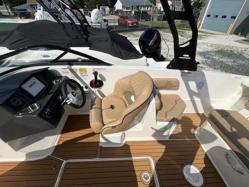 Slide: The Image of 2025 Bayliner VR6 Bowrider OB interior with tan seating and modern dashboard. - 11