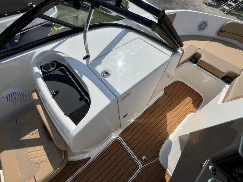 Slide: The Image of 2025 Bayliner VR6 Bowrider OB interior with tan seating and wood-style flooring. - 14