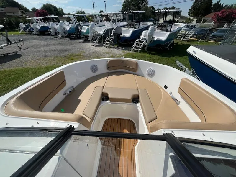 Slide: The Image of 2025 Bayliner VR6 Bowrider OB with tan seating and spacious bow area. - 18
