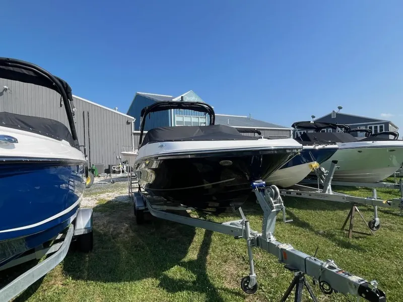 Slide: The Image of 2025 Bayliner VR6 Bowrider OB boats on trailers, displayed outdoors under clear blue sky. - 2